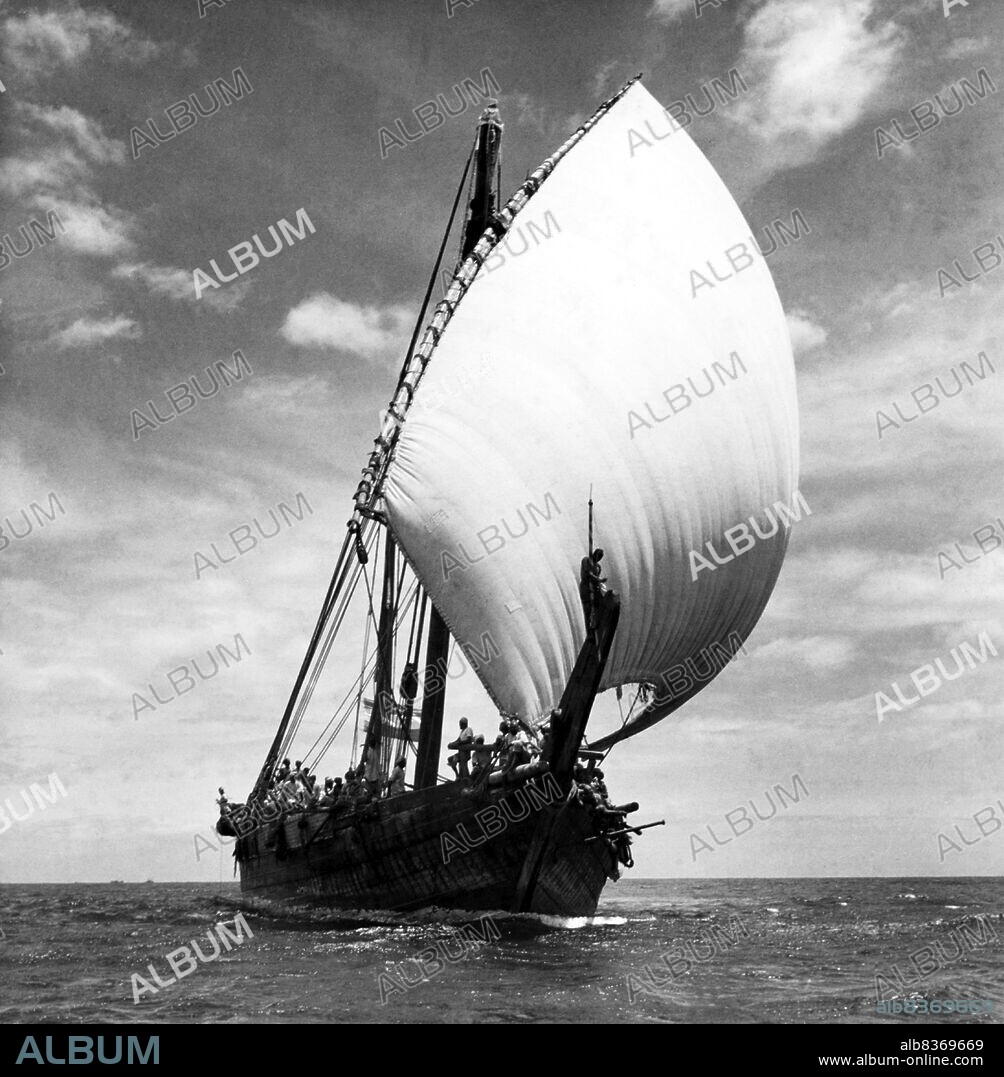A dhow is a traditional Arab sailing vessel with one or more lateen sails. It is primarily used to carry heavy items, like fruit, along the coasts of the Arabian Peninsula, Pakistan, India and East Africa. Larger dhows have crews of approximately thirty people, while smaller dhows typically have crews of around twelve.<br/><br/>. Even down to the present day, dhows make commercial journeys between the Arab or Persian Gulf and East Africa using sails as their only means of propulsion. Their cargo is mostly dates and fish to East Africa and mangrove timber to the lands of the Persian Gulf. They often sail south with the monsoon in winter or early spring, and back again to Arabia in late spring or early summer.<br/><br/>. The term 'dhow' is also applied to small, traditionally-constructed vessels used for trade in the Red Sea and the Persian Gulf area and the Indian Ocean from Madagascar to the Bay of Bengal. Such vessels typically weigh 300 to 500 tons, and have a long, thin hull design.<br/><br/>. Dhow also refers to a family of early Arab ships that used the lateen sail, the latter of which the Portuguese likely based their designs for the caravel (known to Arabs as sambuk, boom, baggala, ghanja and zaruq).