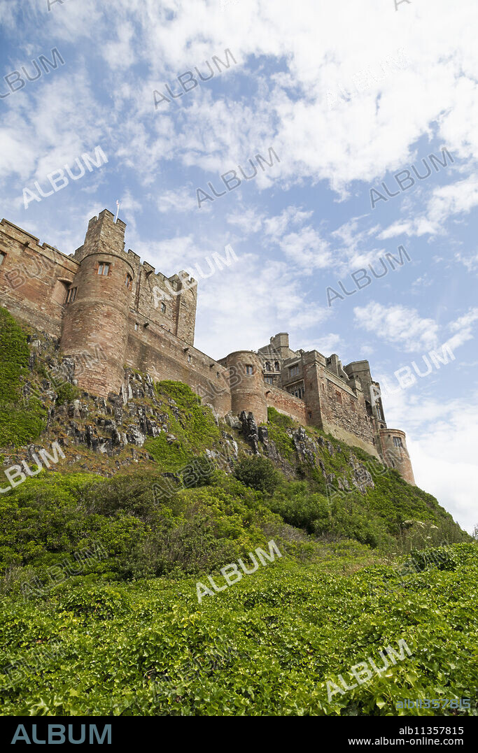 Bamburgh Castle, a hilltop fortress constructed on top of a craggy outcrop of volcanic dolerite, Grade I Listed Building, Bamburgh, Northumberland, England, United Kingdom, Europe.