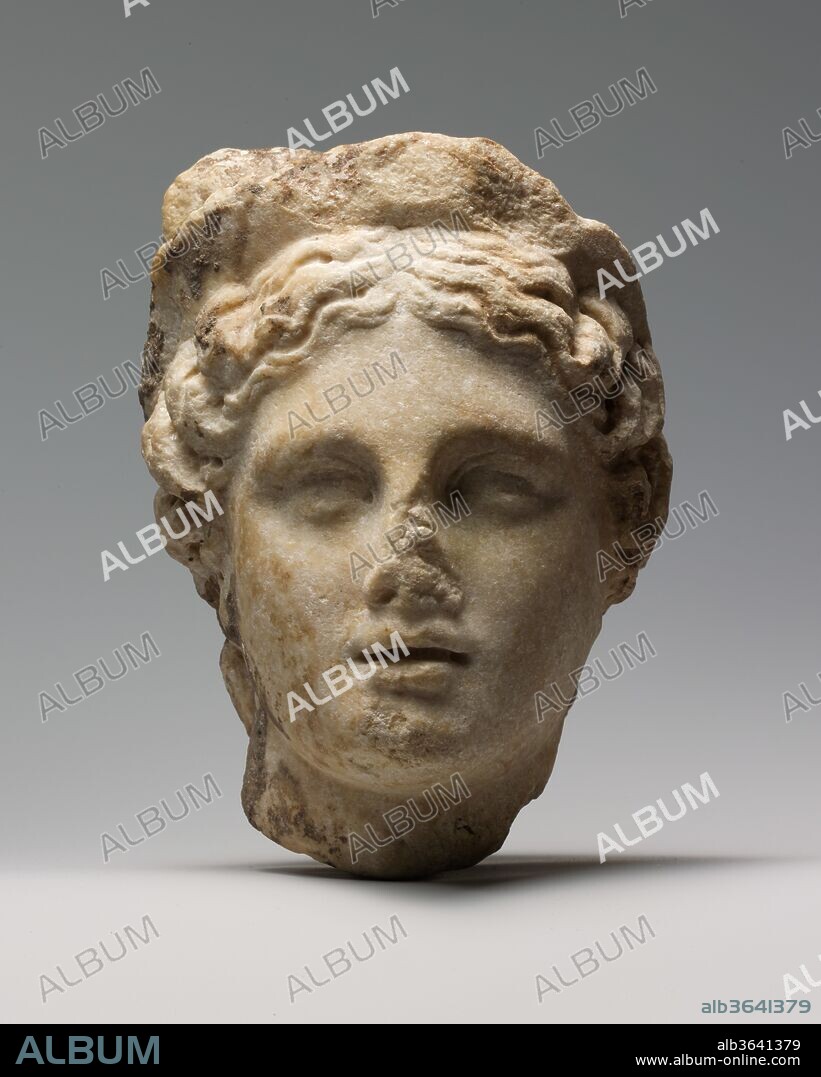 Marble head of a woman wearing a diadem. Culture: Roman. Dimensions: H. 5 7/8 in. (14.9 cm). Date: 1st or 2nd century A.D..
This head probably comes from a small statue of a goddess or a female personification. Although the workmanship appears to be Roman, the style of the face and arrangement of the hair derive from late Classical and early Hellenistic models.