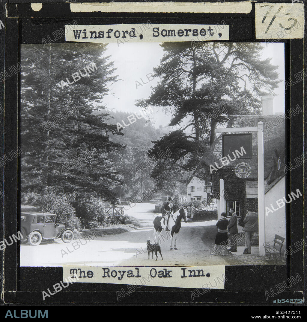 Royal Oak inn, Halse Lane, Winsford, West Somerset, Somerset, 1927-1939. A woman on a horse on Halse Lane watched by three people and a dog outside the Royal Oak Inn. The caption on this slide reads: "Winsford, Somerset, The Royal Oak Inn." The Royal Oak Inn was part of the Acland Estate until 1926. At the estate's auction, the inn was acquired by the People's Refreshments Houses Association, whose sign can be seen on the left of this photograph.
