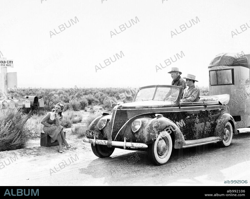JEAN ARTHUR and JOHN WAYNE in A LADY TAKES A CHANCE, 1943, directed by WILLIAM A. SEITER. Copyright RKO.