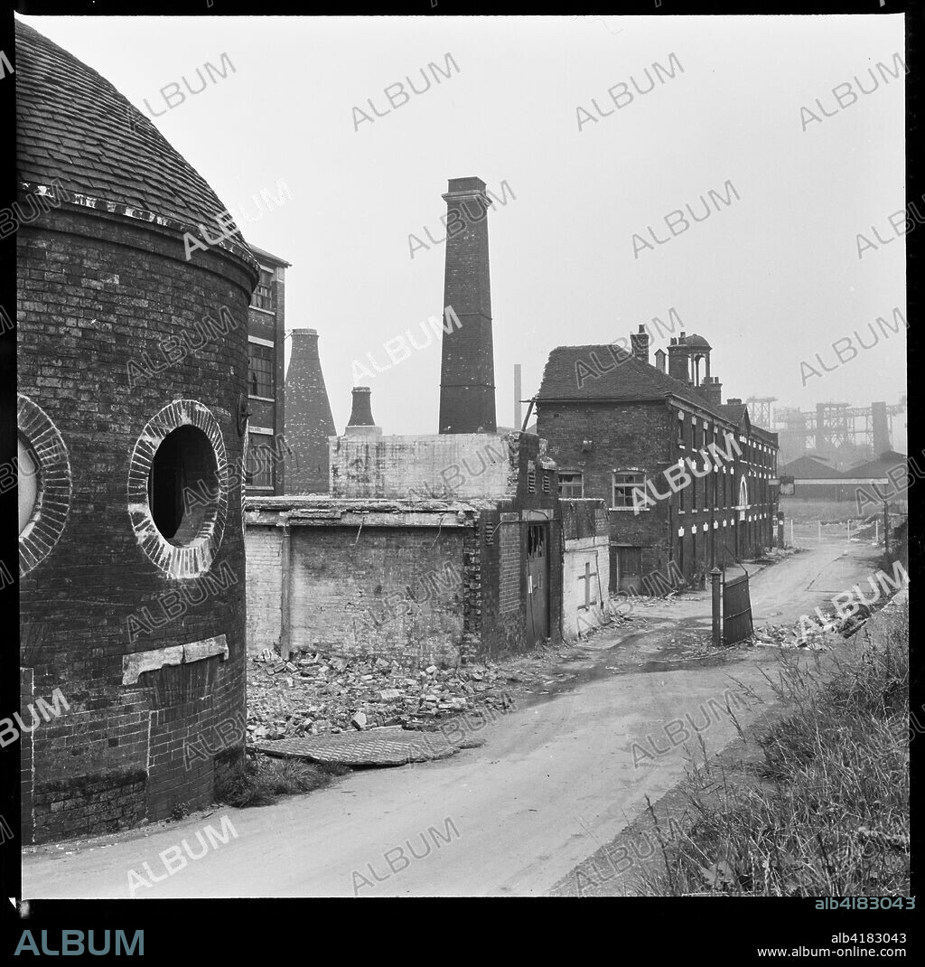 Etruria Pottery Works, Stoke-on-Trent, Staffordshire, 1965-1968. Josiah Wedgwood's Etruria Pottery Works during demolition, viewed from towpath of the Trent and Mersey Canal with the Round House in the foreground. Josiah Wedgwood opened his Etruria Works beside the Trent and Mersey Canal in 1769. A new factory was constructed at Barlaston in 1938 and production was gradually shifted away from Etruria. The Round House (built circa 1769), said to have been used for grinding raw materials, as a counting house, and as a stable, is now the only surviving structure.