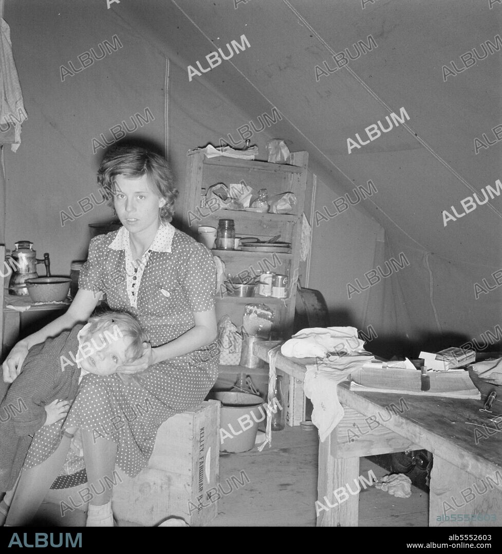 DOROTHEA LANGE. Young mother, aged twenty-two, has one little girl three years old. Merrill, Klamath County, Oregon. In mobile unit of FSA (Farm Security Administration) camp. New baby expected in December. During this year she has worked with her husband in: strawberries (Helvetia, Oregon); cherries (Salem, Oregon); beans (West Stayton, Oregon); hops (Independence, Oregon). Is now in potato pickers' camp at the end of that season. "We haven't got a cent now and we've lost our car because we've helped some people out. It seems like it's taken every cent to eat off, that and traveling around.".