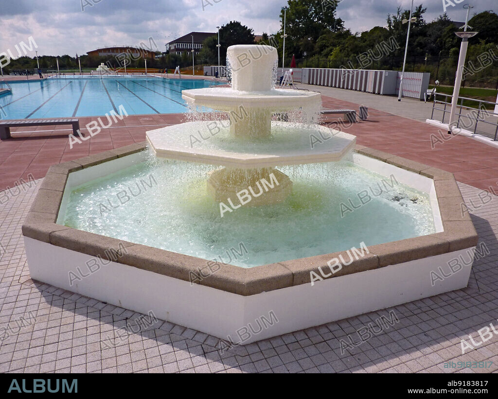 SIMON INGLIS. Hillingdon Sports and Leisure Complex, Gatting Way, Uxbridge, Hillingdon, Greater London Authority, 2010. The restored octagonal aerator fountain at the north end of the outdoor pool at the former Uxbridge Lido, soon after its re-opening as the Hillingdon Sports and Leisure Centre. Uxbridge Lido was opened in 1935. It was designed in a Moderne style by George Percy Trentham. The pool was closed permanently in 1988. It was part of a £31 million redevelopment which saw it become the Hillingdon Sports and Leisure Complex, designed by Faulkner Brown and opened in March 2010. The lido and original buildings are listed Grade II, and is the second longest open air swimming pool in London at 220 foot long (the longest, Tooting Bec Lido, measures 300 foot).