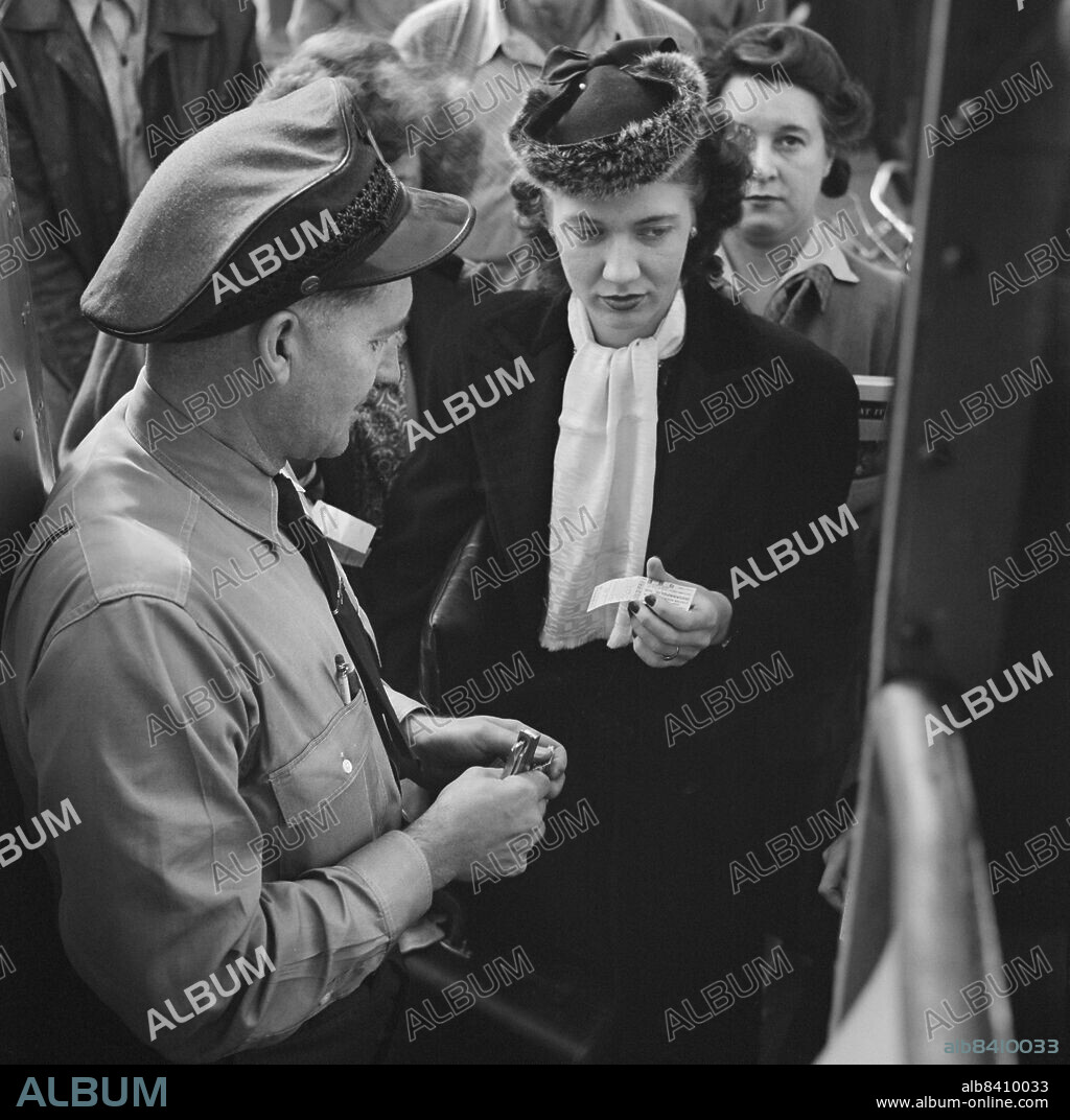 Bus Driver collecting Tickets from People boarding Greyhound bus at small town between Chicago, Illinois and Cincinnati, Ohio, USA, Esther Bubley, U.S. Office of War Information/U.S. Farm Security Administration, September 1943.