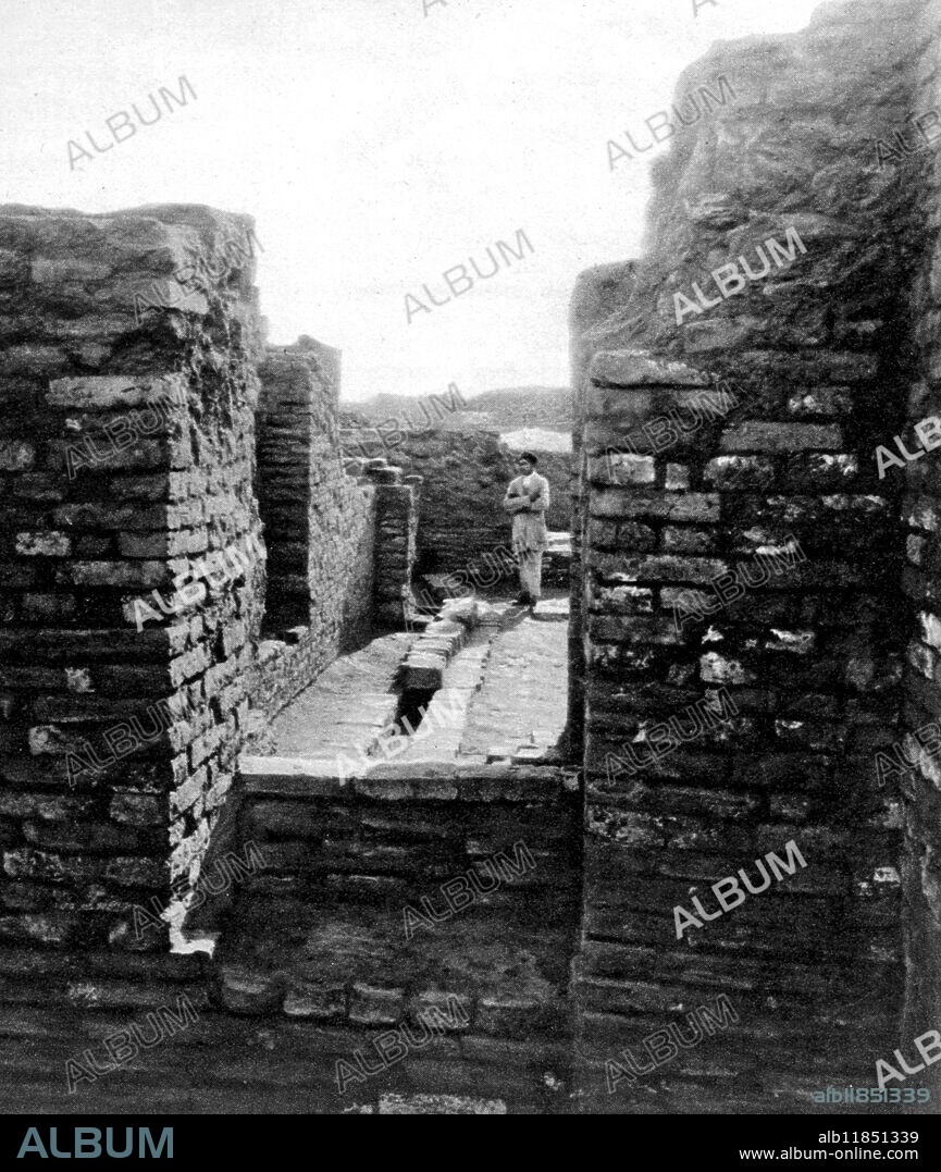 " Modern conveniences" in ancient India: Drains; Rubbish-Chutes. In a 5000-year-old indian town with amenities far in advance of Babylonia or Egypt: the interior of a house at Mohenjo-Daro, showing drains (originally covered under a higher floor-level. 7 January 1928.