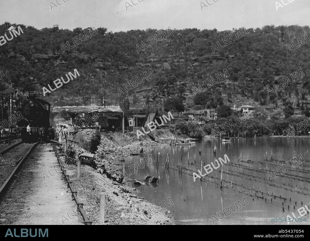Tragic Level - Crossing smash at Hawkesbury River, NSW., When the Kempsey Mail train crashed into a bus at a level-crossing near Hawkesbury River (NSW) station on January 20, 16 bus passengers were killed. Four members of one family were among the victims. The bus was cut in halves and smashed to matchwood. One section with several bodies was carried 400 yards by the locomotive, the tender of which was derailed. The engine is shown above. January 25, 1944. (Photo by Associated Newspapers Ltd.).