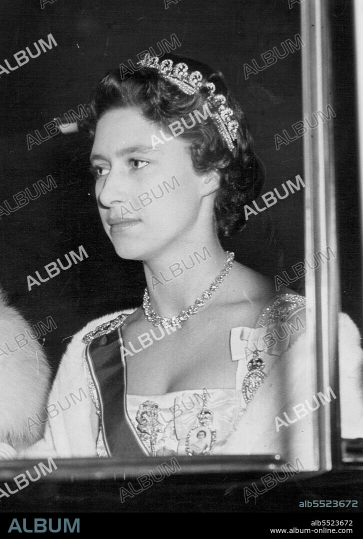 Princess Margaret pictured last night as she drove with the Queen Mother from Clarence House to the State banquet for President Lopes of Portugal and his wife at Buckingham Palace.Controversy about the public actions of Princess Margaret, rarefy far from simmering point in Britain, has boiled over following publication ofa picture of her tiding pillion on a motor bike. October 26, 1955. (Photo by Daily Mirror).