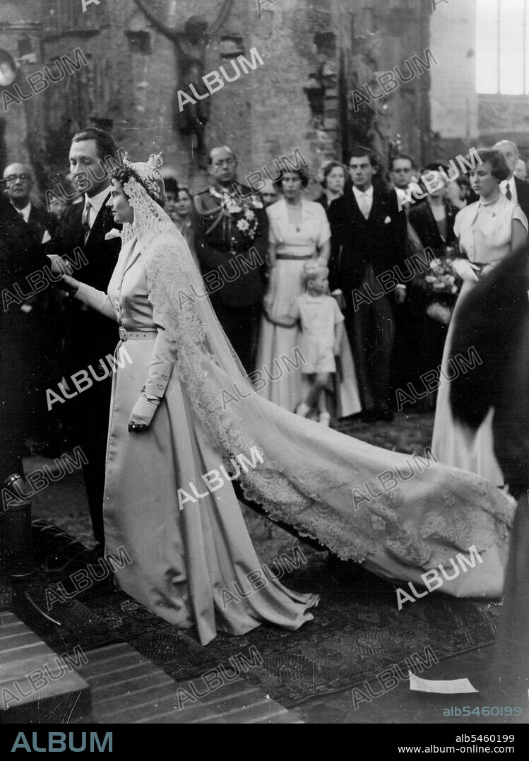 Royalty Weds: Prince Ernst August Von Hanover and Princess Ortrud Zu Schleswig-Hostein Sonderburg-Gluecksburg stand before the altar in the market church during their church wedding ceremony. In background (center), wearing uniform, is King Paul of Greece. September 6, 1951.