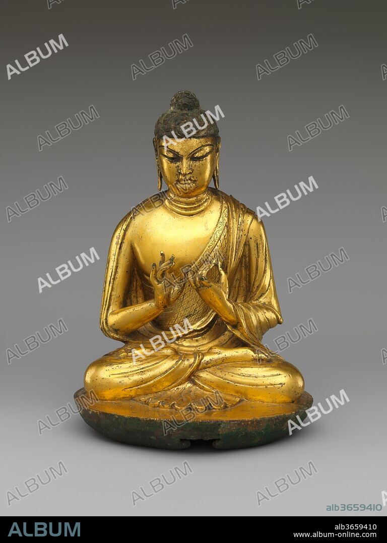 Buddha Vairocana (Dari). Culture: China. Dimensions: H. 8 in. (20.3 cm); W. 5 3/4 in. (14.6 cm); D. 5 1/2 in. (14 cm). Date: early 8th century.
The teaching gesture made by this figure, in which the thumb of the right hand touches the little finger of the left, identifies him as Vairocana, a transcendent manifestation of the historical Buddha Shakyamuni who played an important role in certain early esoteric traditions that grew increasingly popular in China in the eighth century. The unusual wheel-like configuration at the bottom suggests that this sculpture may once have been encased within five lotus petals that could open and close.