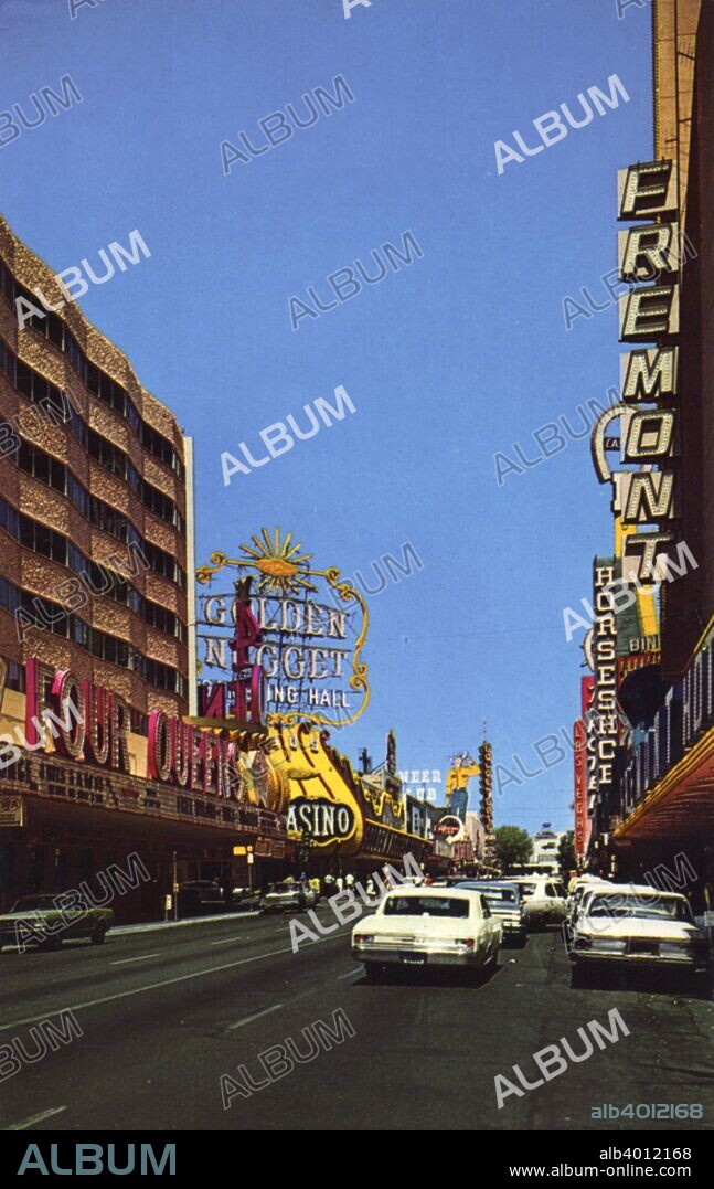 Fremont Street, Las Vegas, Nevada, USA, 1968. Vintage postcard showing Fremont Street and all the neon signs announcing the clubs, casinos and hotels. The Four Queens and Golden Nugget casinos and the Fremont Hotel are prominent and cars travel along the street.
