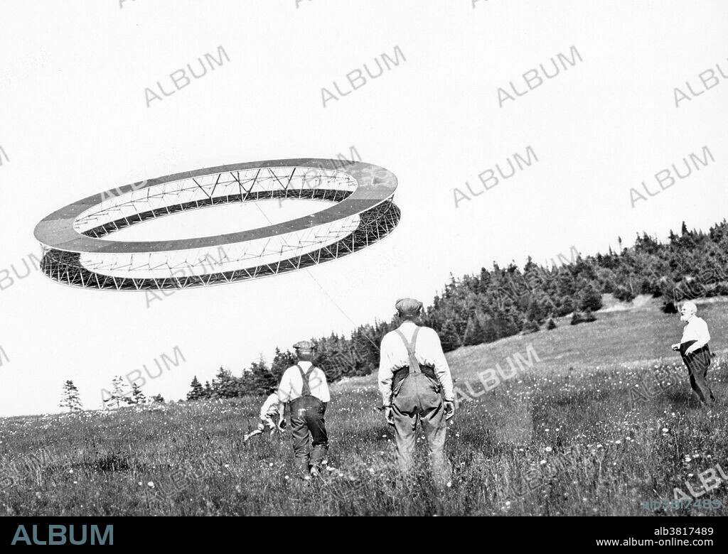 Bell (right) and his assistants observing the progress of one of his tetrahedral kites. Alexander Graham Bell (March 3, 1847 - August 2, 1922) was a Scottish-American speech therapist and inventor of the telephone. Bell followed his father and grandfather into the speech therapy profession, but also studied sound waves and the mechanics of speech. By 1871, he had moved to the USA, becoming professor of vodal physiology in Boston. There he performed his experiments in converting sound waves into electrical impulses for transmission down wires. In 1876, he patented the telephone and founded what has become the AT&T company. In later years he made many improvements to the telephone, worked with Langley and Curtis on flying machines, and founded the journal "Science." He died of complications arising from diabetes in 1922 at the age of 75. His coffin was constructed of Beinn Bhreagh pine by his laboratory staff, lined with the same red silk fabric used in his tetrahedral kite experiments. No photographer credited, July 7, 1908.