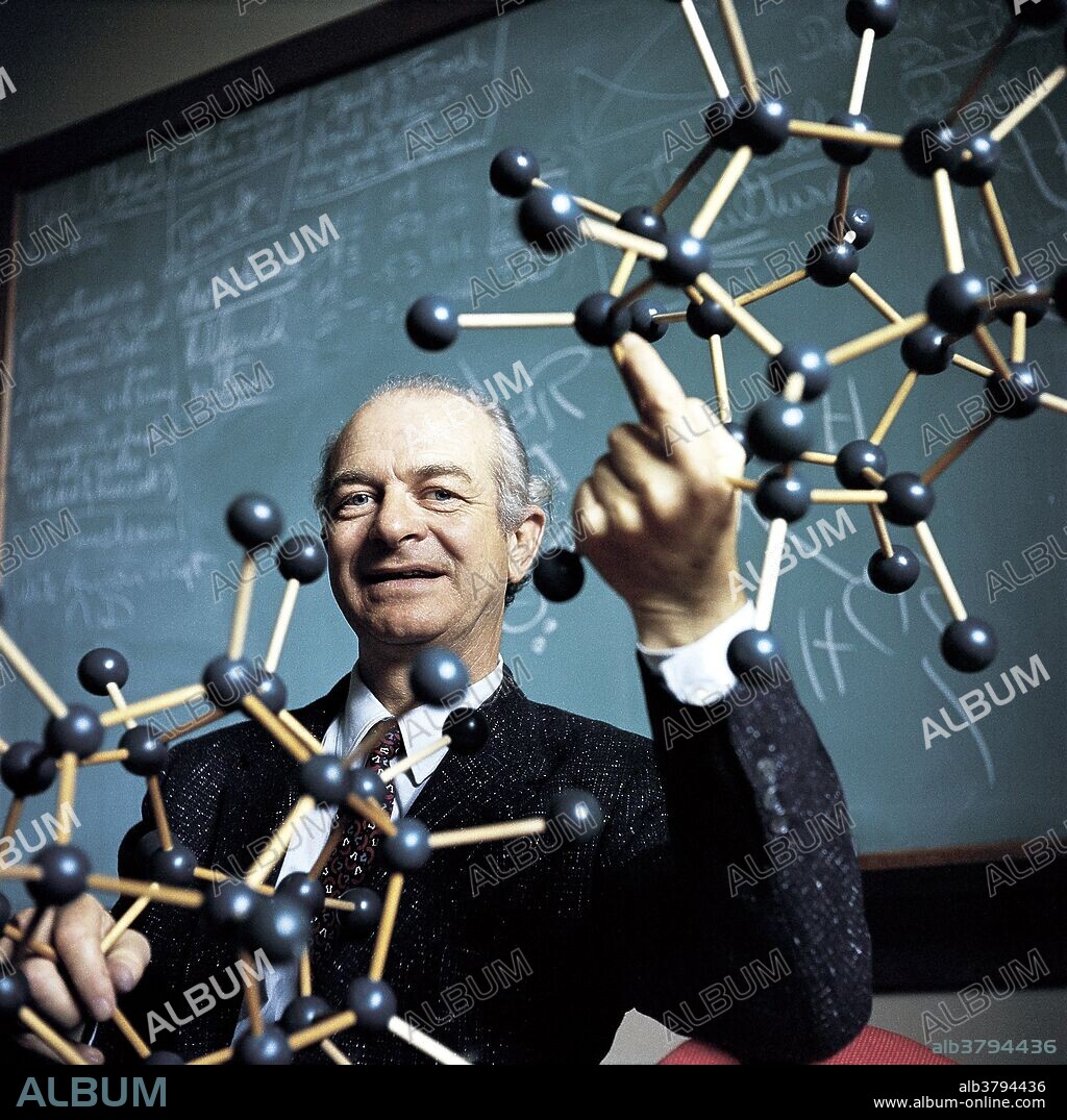 A portrait of Dr. Linus Pauling holding arrangements of water molecules in a classroom at the California Institute of Technology. Dr. Linus Pauling won the Nobel Prize in Chemistry in 1954.