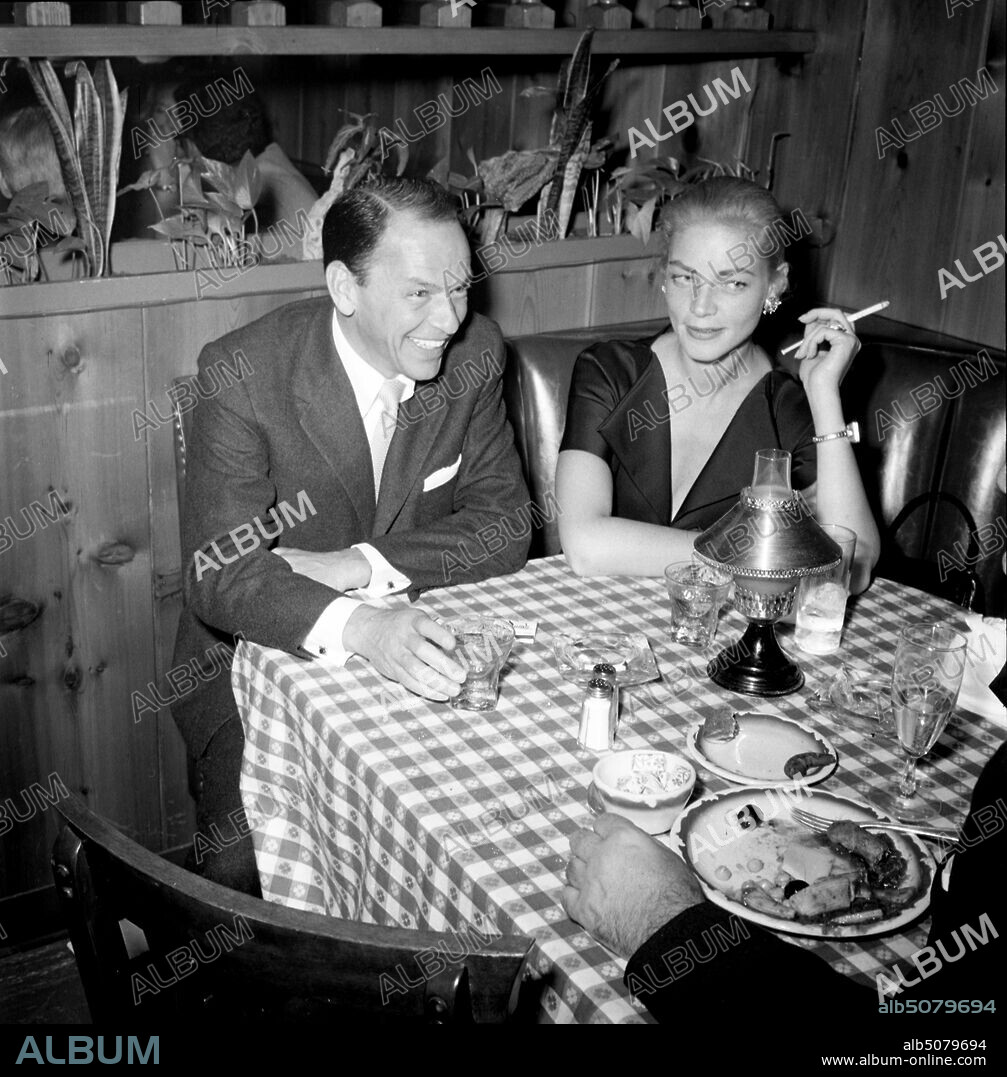 LAUREN BACALL. January 1, 1955, Los Angeles, California, USA: Actors FRANK SINATRA and LAUREN BACALL entertaining guests at a restaurant in Hollywood.
