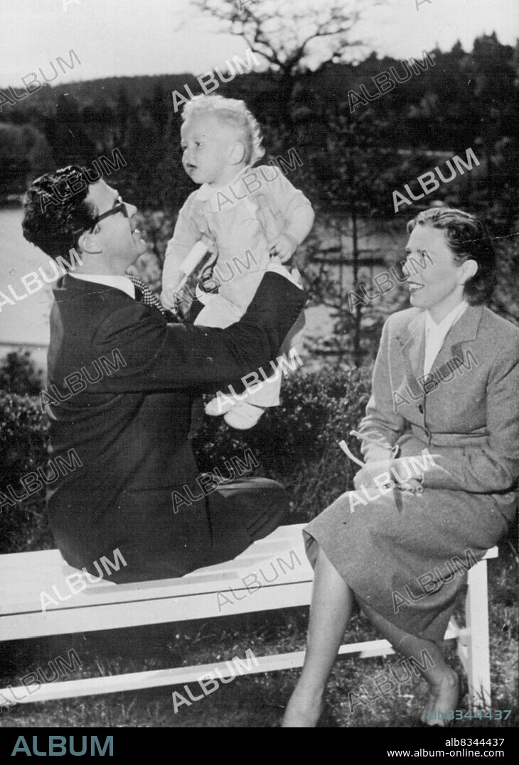 Photo Shows: Mr.Carl Bernadotte with his wife Kerstin and their adopted eon Christian, in the gardens of their home in Stockholm. 
Orphan Adopted by Sweden's Ex-Prince - A 14 months old Swedish orphan - without family name- has now been adopted by Mr.Carl J. Bernadotte and his wife and takes the name of the Swedish Royal House.
Mr. Carl J. Bernadotte Was formerly Prince Carl Johan of the Swedish King, but who renounced his titles to marry an American wife. June 05, 1951. (Photo by Sport and General Press Agency Limited).