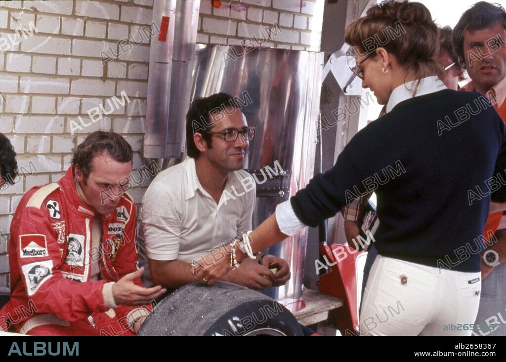 Niki Lauda with his wife Marlene and Mauro Forghieri, technical director of the Scuderia in the Ferrari pits in 1976.