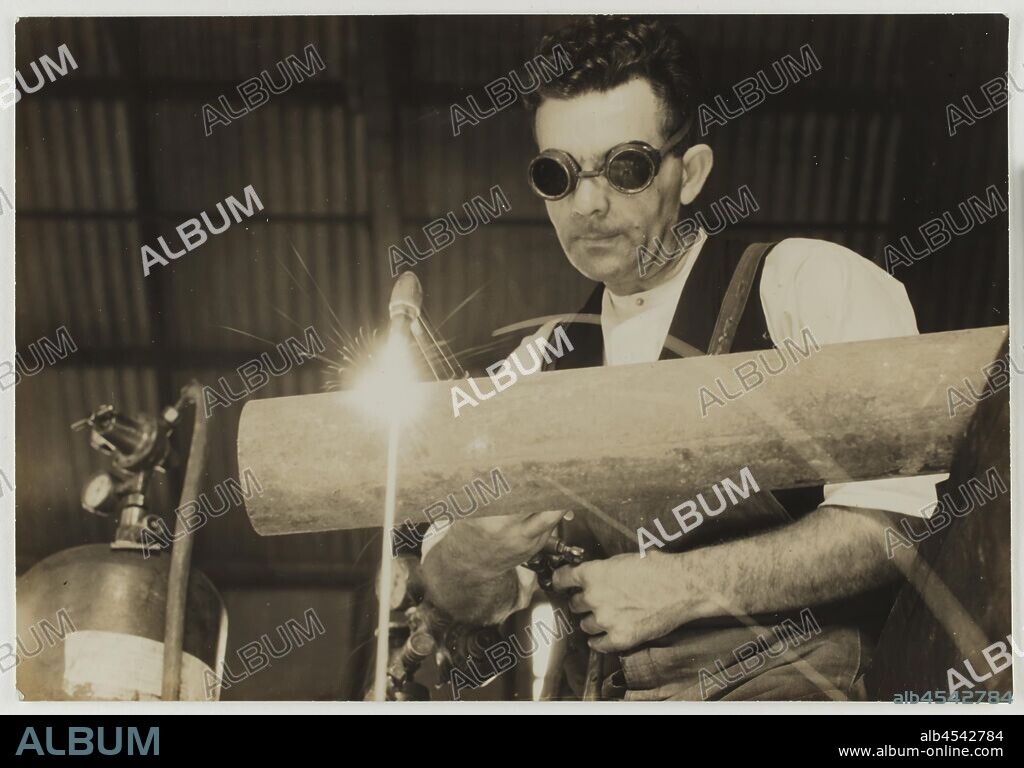 Photograph, Jim Myers Welding Pipe, Abbotsford, Victoria, 1930s, Monochrome photograph of Jim Myers, a former Kodak Australasia employee, oxy acetylene welding a pipe in the Kodak factory workshops in Abbotsford, Victoria, circa 1930s.