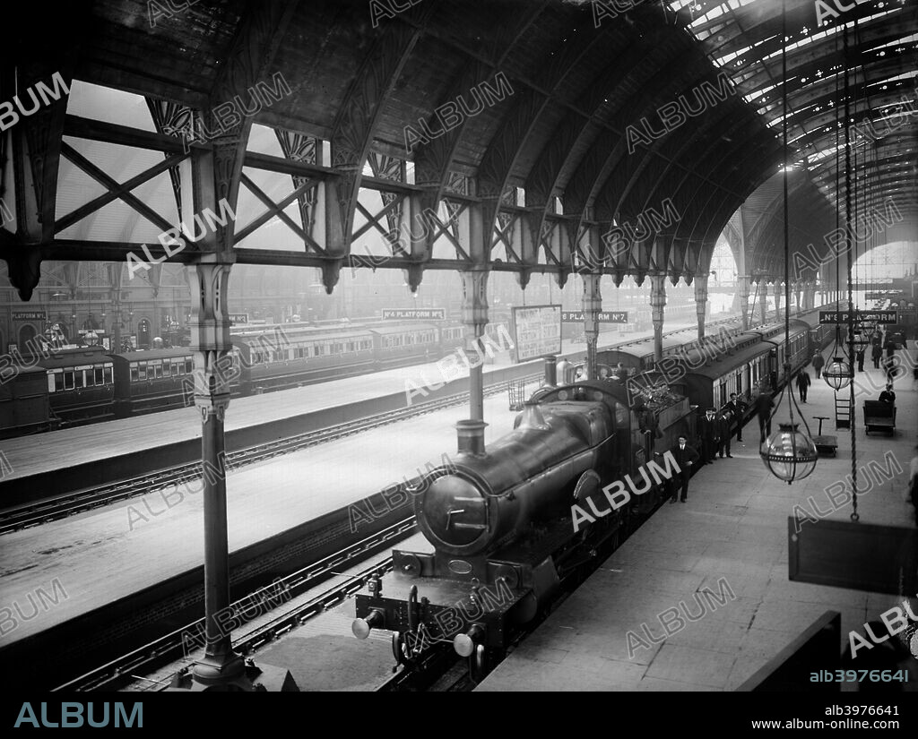 Locomotive at Paddington Station, Praed Street, Westminster, London. A steam locomotive stands on platform 8, while the driver and porters pose next to the train. Paddington was built in 1850-4 as the London terminus for the Great Western Railway.