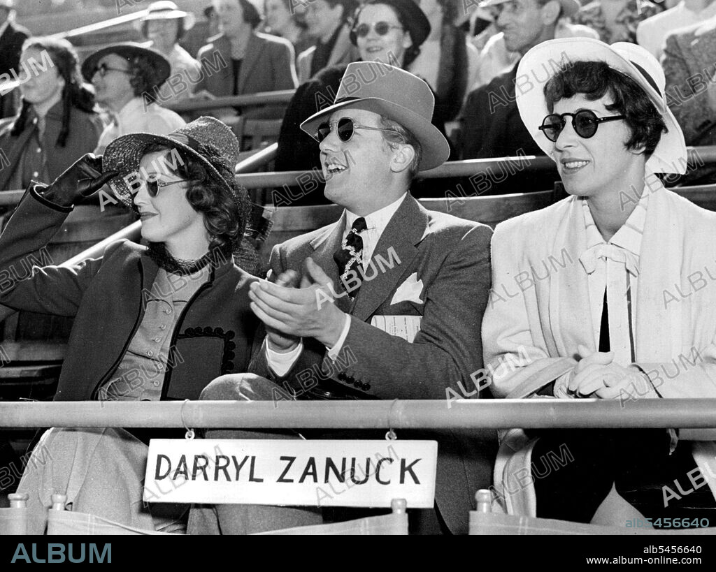 Jeanette MacDonald, Gene Raymond and publicist Helen Ferguson don dark goggles and take ofer the Zanuck box to look for a photo finish at the races. June 4, 1940. (Photo by Wide World Photos).
