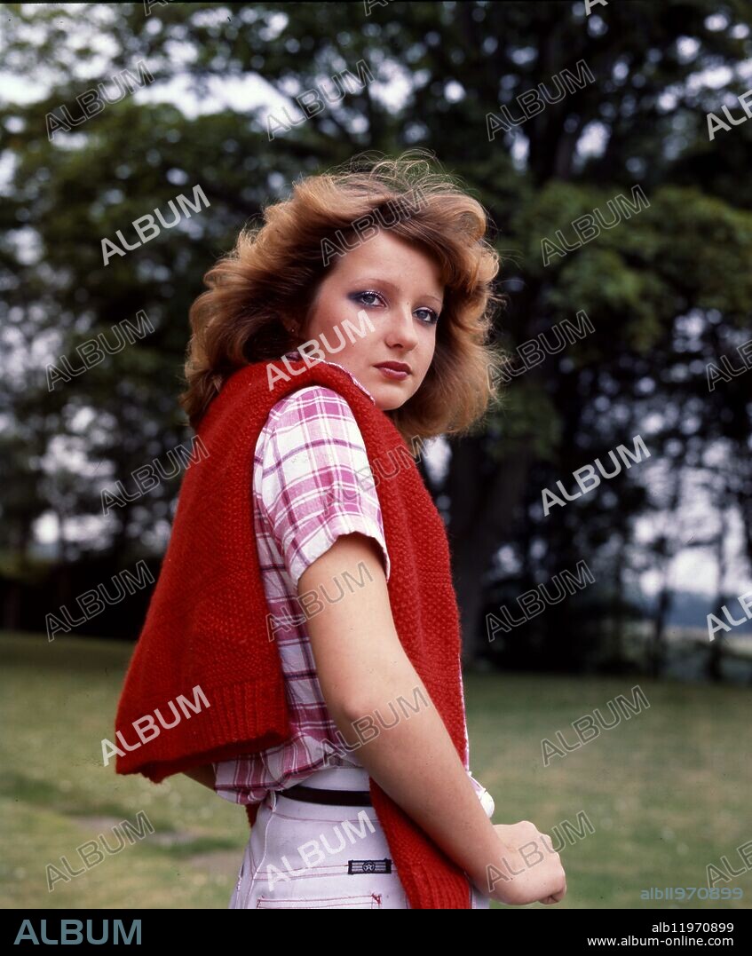 Young brunette woman with red jumper.