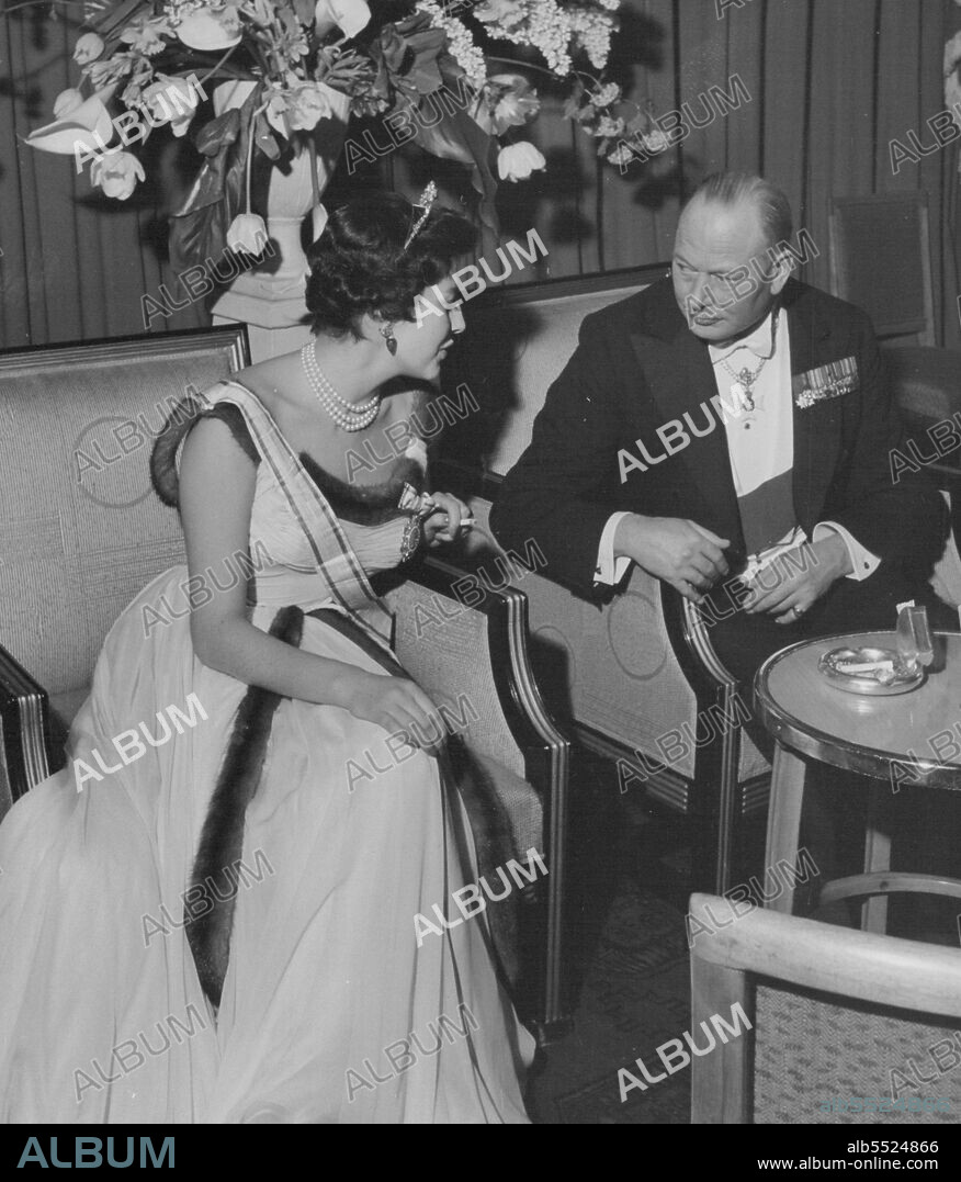 A Radiant Queen -- The Shah of Perisa and Queen Soraya received specially  invited guests  at the Savoy Hotel, London, on Monday evening. Among those present were the lord chancellor, Lord Kilmuir, Mr. Harry Crookshank, leader minister, The lovely Queen Soraya was the centre of attraction. The women discussed her and the men admired her. August 22, 1955. (Photo by Daily Express).