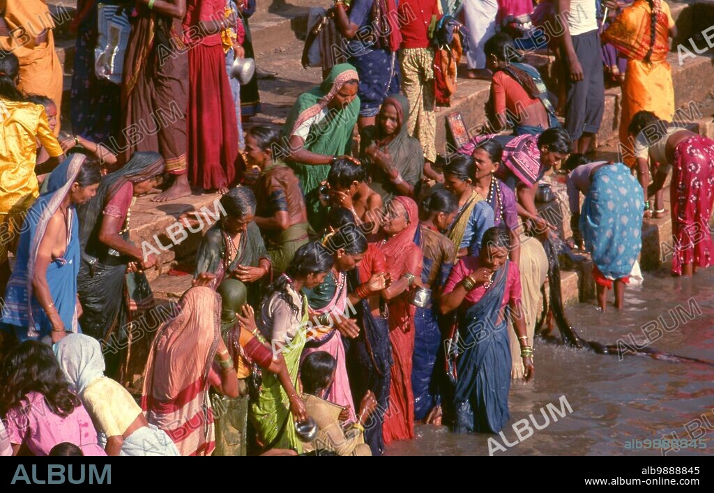 India: Pilgrims bathing at the Jogula Bhavi holy tank, Saundatti, Karnataka, during the Shri Yellamma Devi Fair (1994). Every year in the Hindu month of Magh (January - February) more than half a million people gather around the tiny temple of the goddess Yellamma in Saundatti. Yellamma is the patron of the devadasi or women dedicated to the service of a deity or temple.