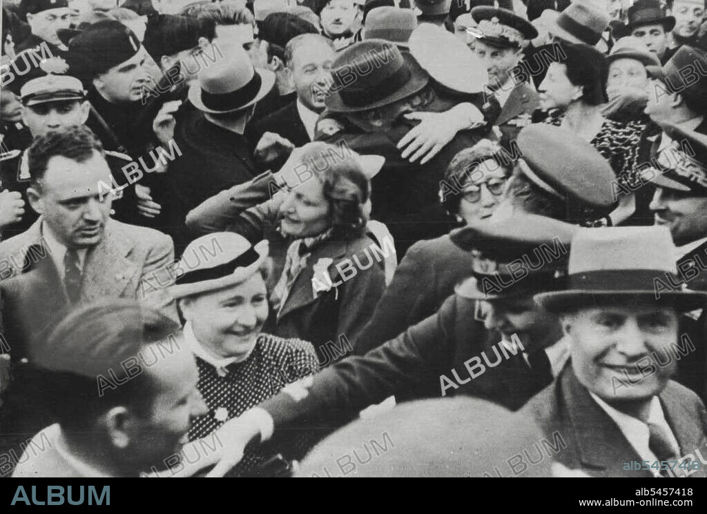 Proud Duce Greets His Sons -- In foreground Signora Mussolini, Bruno Mussolini (hand outstretched) and Il Duce (in soft hat). In background count Ciano, son in law of Il Duce, is being affectionately embaraced by his father.Flight Lieuts. Bruno and Vittorial Mussolini, the sons of Il Duce, were given a warm welcome by their father and other members of the family, when they arrived at Littoria aerodrome here form service in Abyssinia. Both sons distinguished themselves in aerial campaigns against the Abyssinaans. They were accompanied by count ciano, Mussolini's son-in-law. June 6, 1936.