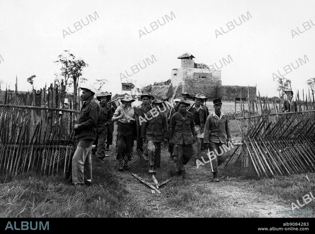 March 1951: Men of the 5th Foreign Legion infantry regiment armed with picks and shovels leave the stockade of the French outpost at Viet Trih, Northern Indo-China, March 3rd to work on a building of concrete defence posts in the area. They are led by Sgt. Leandro Bettini of Pisario, Italy.