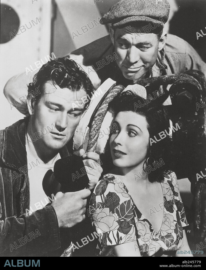 CARMEN MORALES, JOHN WAYNE and WARD BOND in THE LONG VOYAGE HOME, 1940, directed by JOHN FORD. Copyright UNITED ARTISTS.