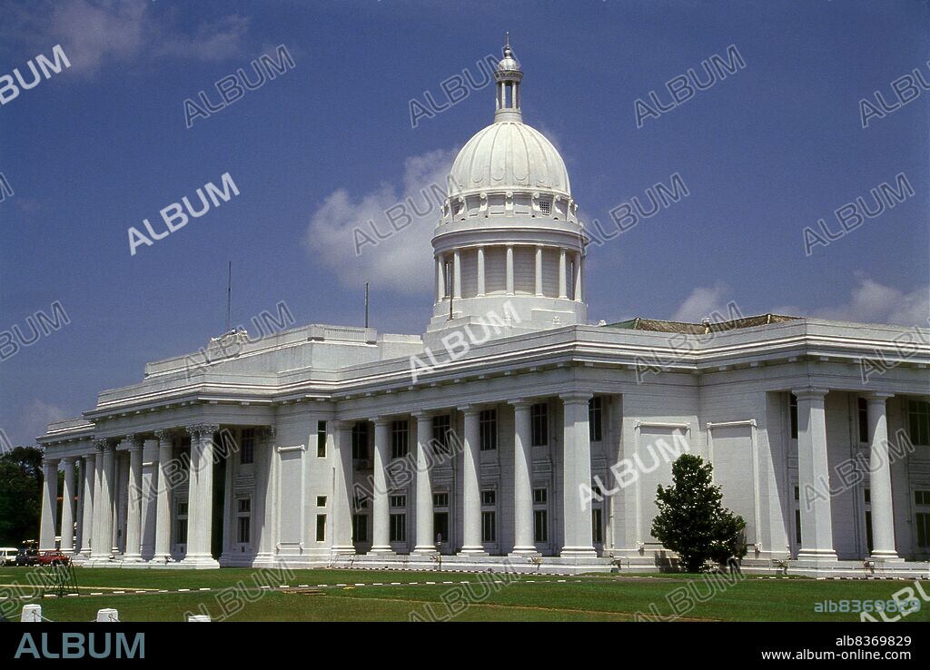 Colombo's Town Hall, designed by S. J. Edwards, was completed in 1927 during the British colonial era.<br/><br/>. Colombo is the largest city and former capital of Sri Lanka. It is located on the west coast of the island, adjacent to Sri Jayawardenapura Kotte, the capital.<br/><br/>. Colombo is a busy and vibrant city with a mixture of modern life and colonial buildings and ruins. It has a city population of 647,100 (2010). Due to its large harbour and its strategic position along the East-West sea trade routes, Colombo was known to ancient traders 2,000 years ago. However it was only made the capital of the island when Sri Lanka was ceded to the British Empire in 1815, and its status as capital was retained when the nation became independent in 1948.<br/><br/>. In 1978, when administrative functions were moved to Sri Jayawardenepura Kotte, Colombo was designated as the commercial capital of Sri Lanka. Like many cities, Colombo's urban area extends well beyond the boundaries of a single local authority, encompassing other municipal and urban councils. The main city is home to a majority of Sri Lanka's corporate offices, restaurants and entertainment venues. Famous landmarks in Colombo include Galle Face Green, Viharamahadevi Park and the National Museum.