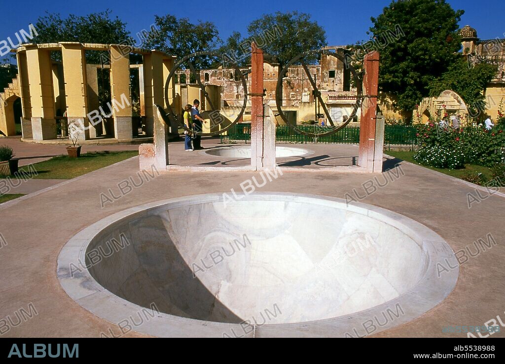 The Jantar Mantar is a collection of architectural astronomical instruments, built by Maharaja Sawai Jai Singh who was a Rajput king. The observatory consists of fourteen major geometric devices for measuring time, predicting eclipses, tracking stars' location as the earth orbits around the sun, ascertaining the declinations of planets, and determining the celestial altitudes and related ephemerides. Jaipur is the capital and largest city of the Indian state of Rajasthan. It was founded on 18 November 1727 by Maharaja Sawai Jai Singh II, the ruler of Amber, after whom the city was named. The city today has a population of 3.1 million. Jaipur is known as the Pink City of India. The city is remarkable among pre-modern Indian cities for the width and regularity of its streets which are laid out into six sectors separated by broad streets 34 m (111 ft) wide. The urban quarters are further divided by networks of gridded streets. Five quarters wrap around the east, south, and west sides of a central palace quarter, with a sixth quarter immediately to the east. The Palace quarter encloses the sprawling Hawa Mahal palace complex, formal gardens, and a small lake. Nahargarh Fort, which was the residence of the King Sawai Jai Singh II, crowns the hill in the northwest corner of the old city. The observatory, Jantar Mantar, is a World Heritage Site.