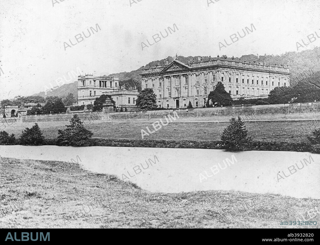 Chatsworth House from across the River Derwent, Derbyshire, late 19th or early 20th century. The first house at Chatsworth near Bakewell in Derbyshire was built by Bess of Hardwick (c1527-1608) and her second husband Sir William Cavendish (1505-1557). Building began in 1552, and many additions and alterations were made over the years by its subsequent occupants. Chatsworth House has been the seat of the Dukes of Devonshire since 1687.