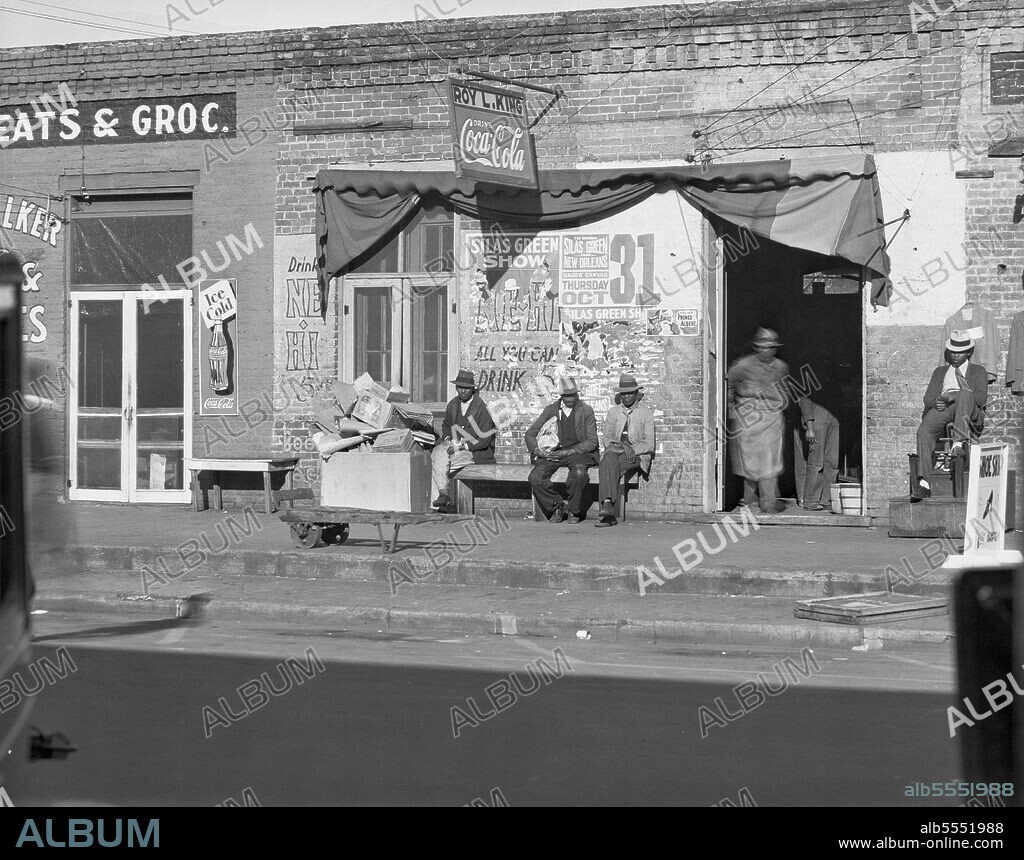 WALKER EVANS. Sidewalk scene in Selma, Alabama. [African Americans outside a shop run by Roy L. King; signs for Coca-Cola, 'the Original Silas Green from New Orleans, under canvas' Thursday 31 October; Prince Albert tobacco].