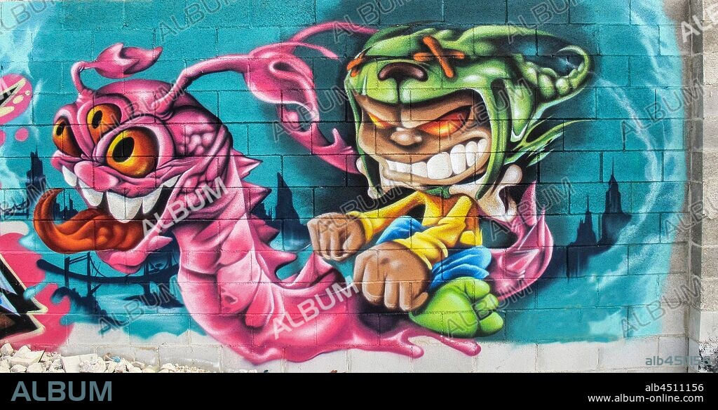 Ilustracion estilo comic de pequeño demonio montado sobre un dragón con tres ojos, graffiti mural, Plaza de las Glorias; Distrito San Martin, Barcelona en 2014.