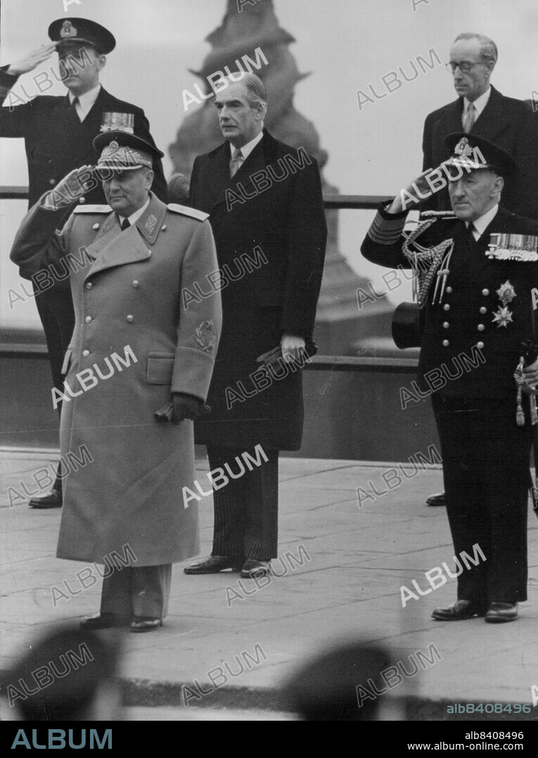 Tito At Farewell To Britain Parade -- President of Yugoslavia, wearing full uniform with light grey greatcost and with scarlet Lapels seen saluting  as he inspected the Naval Guard of Honor at Westminster Pier. London, before embarking in a port of London Authority vessel to travel down the Thames to the Yugoslav Training ship 'Galeb'. The Marshal was leaving after his five-day visit to Britain. On right is Britain's First Sea Lord Admiral Sir Rhoderick McGrigor, and back is Mr. Anthony Eden, Britain's Foreign Minister. March 21, 1953. (Photo by Reuterphoto).