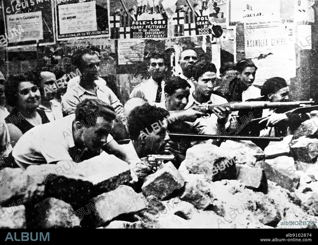 July 22nd 1936: Spain/ Barcelona: Fascist rebellion. Republican volunteers variously armed with rifles and revolvers, manning a brick barricade during a street battle in Barcelona. The Republicans have been armed by the government.