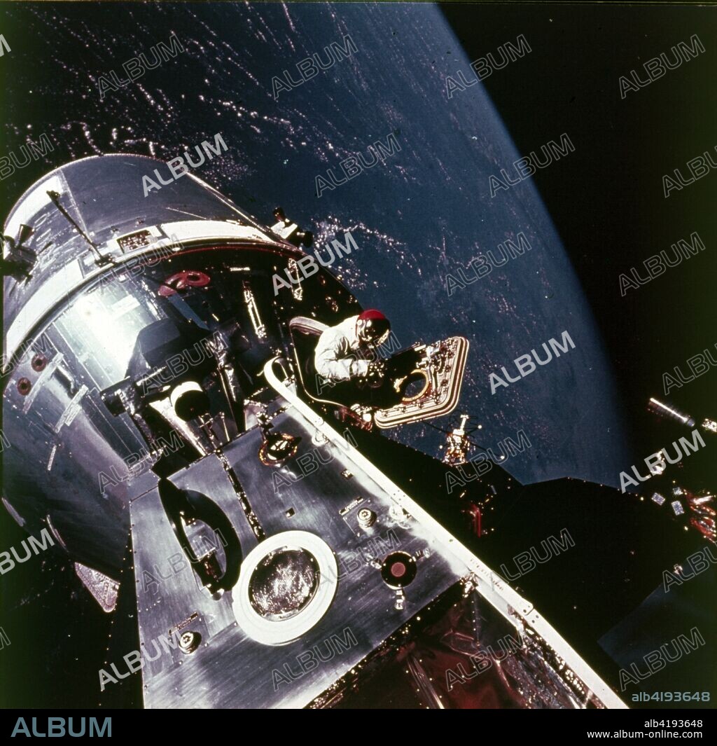 Module pilot David Scott emerging from Apollo 9 spacecraft, 6 March 1969. Apollo 9 Command/Service Modules (CSM) nicknamed 'Gumdrop', and Lunar Module (LM), nicknamed 'Spider' are shown docked together as Command Module pilot David R Scott stands in the open hatch. Astronaut Russell L Schweickart, Lunar Module pilot, took this photograph of Scott during EVA (Extravehicular activity). Inside the lunar module was Apollo 9 commander Jim McDivitt. The crew tested the orbital rendezvous and docking procedures that made the lunar landings possible.