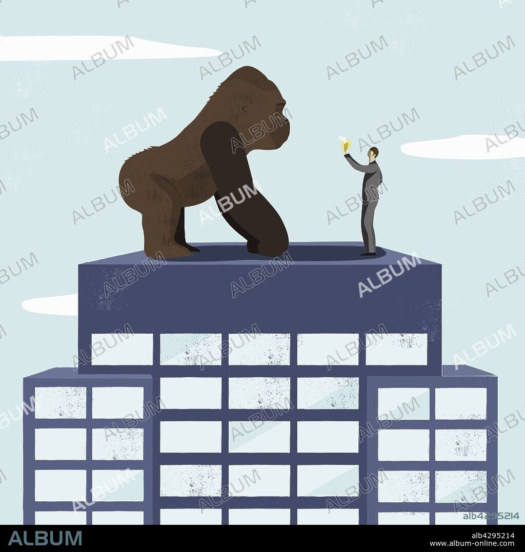 Businessman offering banana to large gorilla on top of tall building.