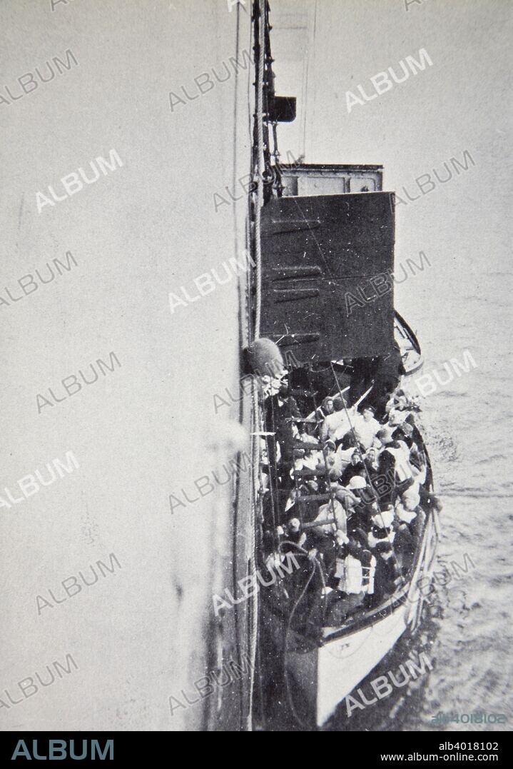 View from the 'Carpathia' of a lifeboat from the 'Titanic' brought alongside, 15 April, 1912. Operated by the White Star Line, RMS 'Titanic' was the largest and most luxurious ocean liner of her time, and thought to be unsinkable. During her maiden voyage, bound for New York, she struck an iceberg in thick fog off Newfoundland on 14 April 1912. In the collision five of her watertight compartments were compromised and she sank. Out of the 2228 people on board, only 705 survived. A major cause of the loss of life was the insufficient number of lifeboats she carried. The RMS 'Carpathia' responded to the 'Titanic''s distress call and arrived at the scene of the sinking around four hours later.