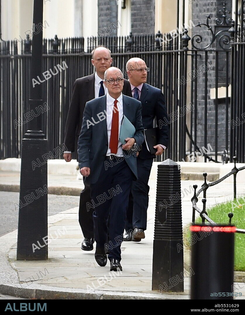 Prof Chris Whitty, the UK government's Chief Medical Officer, and Sir Patrick Vallance, British Government Chief Scientific Adviser and Head of the Government Science and Engineering, leave No.10 Downing Street to attend a press briefing headed by the UK PM Boris Johnson which outlined a relaxation of lockdown rules amid the COVID-19 Coronavirus pandemic. July 2021.