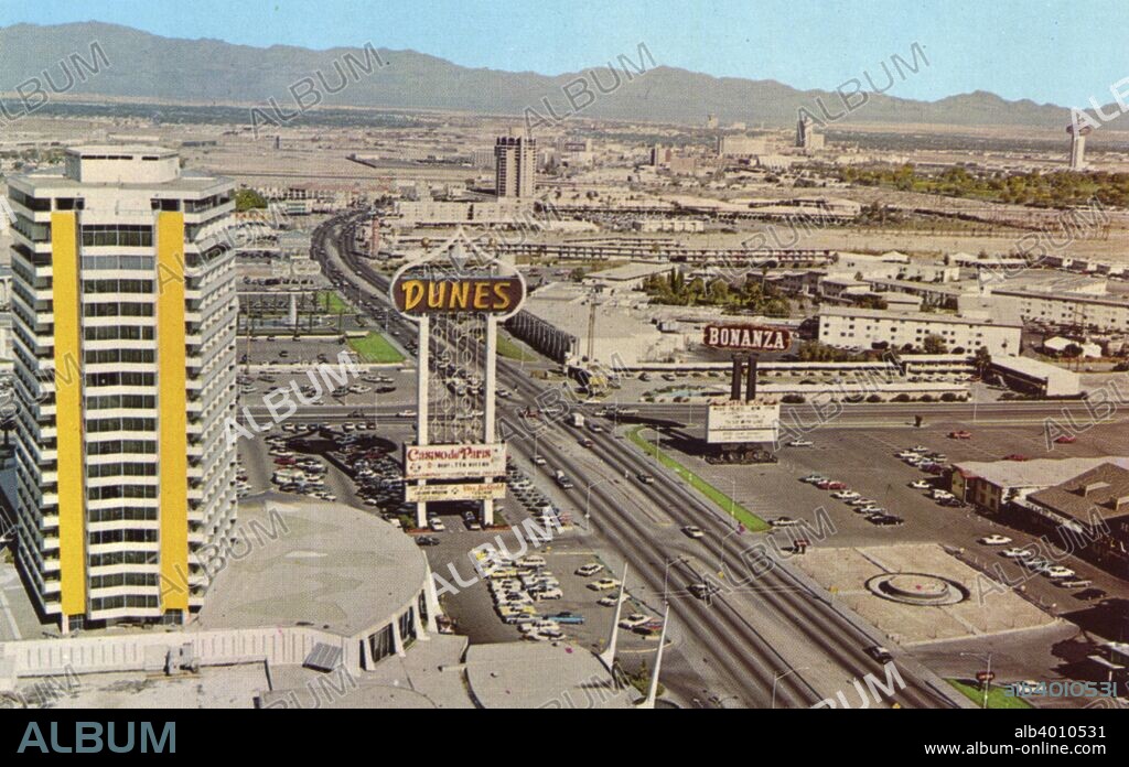 The Dunes Hotel and the Strip, Las Vegas, Nevada, USA, 1967. Vintage postcard showing a bird's eye view of the Dunes hotel, the Las Vegas Strip and outlying area. Mountains are seen in the distance. The tenth casino hotel to be built on The Strip, the Dunes opened in 1955. It closed in 1993 and the Bellagio now stands on the site.
