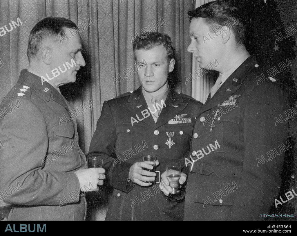 Airmen Heroes Of Great Air Battle Decorated -- Lt. Gen. Carl Spaatz, (left) Commanding the U.S. Strategic Air Forces in Europe, chatting with Captain Ray S. Wetmore, of Kerman. Calif; (center) and Lt. Col. Robert P. Montgomery of Bethlehem, Pa., after decorating them with the distinguished Services Cross.Capt. Wetmore led a formation of six Mustangs and repeatedly engaged large formations of the enemy, destroying two enemy fighters himself: while Lt. Col. Montgomery led his section of eight Mustangs during the battle, destroying three enemy planes himself while his command accounted for twenty-eight.Some of the airmen heroes of the recent great battle over Germany when 208 out of an estimated 400 German fighters were destroyed, were decorated by Lt. Gen. Gail Spaatz at an airfield somewhere in England. November 5, 1944.