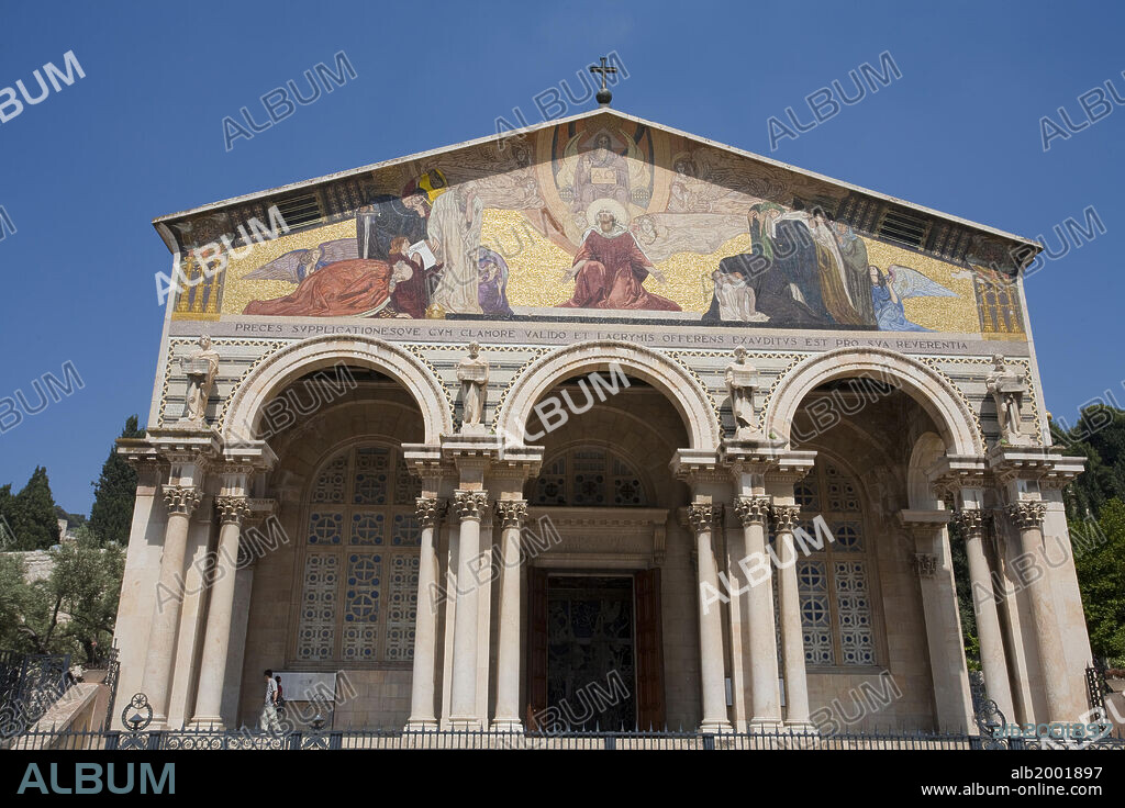 The Church of All Nations, officially named the Basilica of the Agony, is located at the base of the Mount of Olives in Jerusalem. Next to the Garden of Gethsemane that is thought to be where Jesus prayed on the night of his arrest (Matthew 26:36). The Basilica of the Agony was built between 1919 -1924 using funds from 12 different countries. Therefore, it was called the Church of All Nations. The Church has a domed roof, thick pillars, and floor mosaic reminiscent of the Byzantine period. The architect of the building was Antonio Barluzzi. The symbols of the 12 different countries are incorporated into the gold ceilings of 12 cupolas. The 12 cupolas rest on six monolithic pillars. The front of the church features a colorful facade held up by a row of pillars. The mosaic above the entrance depicts Christ as the link between God and humanity.  The Church of All Nations is run by the Franciscans. The Church of All Nations lies on the foundations of two earlier churches: a 12th-century Crusader chapel abandoned in 1345 and a 4th-century Byzantine basilica, destroyed by an earthquake in 746.