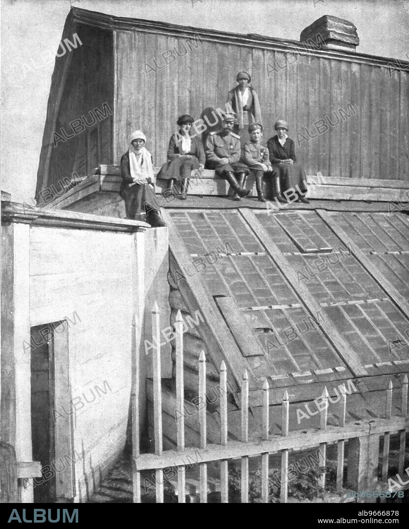 ''Les Romanof a Tobolsk; Le tsar et ses enfants venus chercher sur la toiture d'une serre un rayon de soleil siberien. De gauche a droite, les grandes-duchesses Olga et Anastasie, le tsar, le tsarevitch, la grande-duchesse Tatiana; debout, la grande-duchesse Marie', 1917. From "L'Album de la Guerre 1914-1919, Volume 2" [L'Illustration, Paris, 1924].