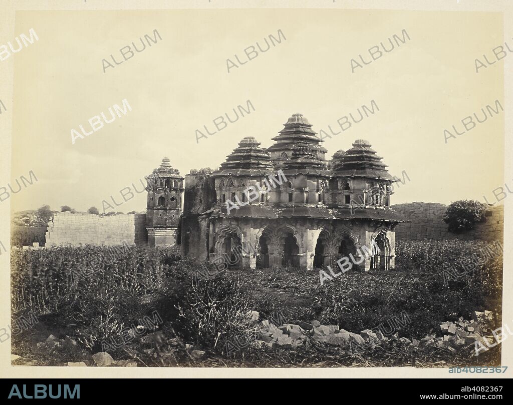 EDMUND DAVID LYON. Ruins of Vijianuggur [Vijayanagara], near Calamapoor [Kamalapuram]. Ruins of the Harem [Lotus Mahal]. A view of the Lotus Mahal from the other side, showing the nine towers, with entrances in the form of multi-lobed arches. Probably a residence of the king or his military commander. Lyon Collection: Photographs to Illustrate the Ancient Architecture of Southern India, by Captain Lyon. [Vol. VI]. c. 1868. Photograph. Source: Photo 212/6(37).