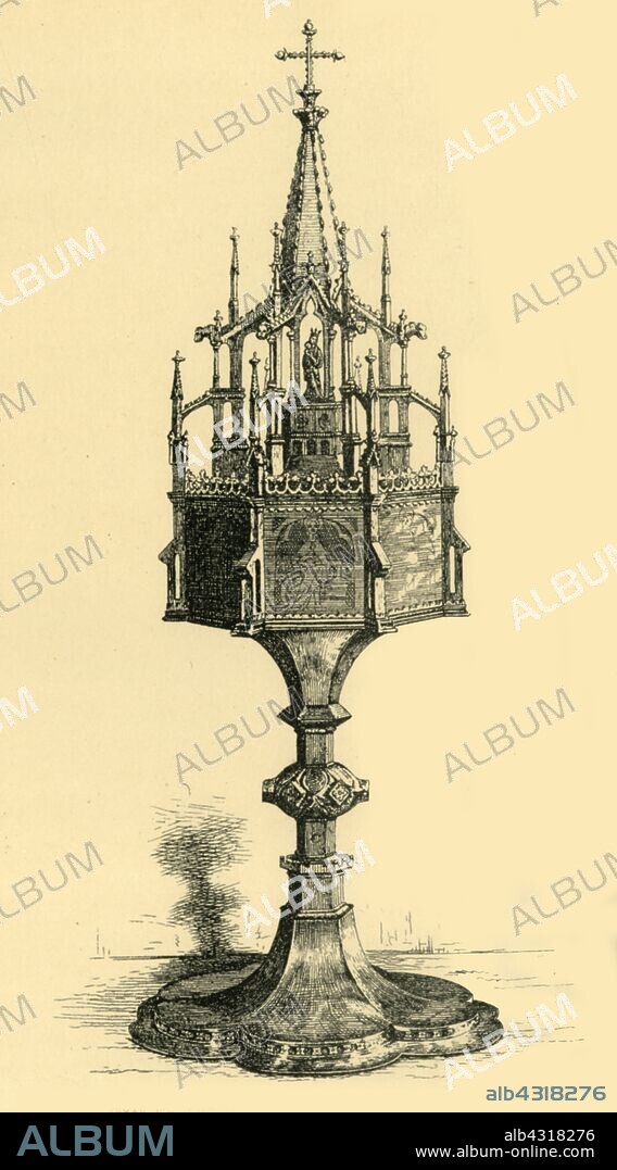 R I STEVENSON. Pyx, early-mid 19th century, (1881). Etching of a silver-gilt pyx made in a workshop in the Rhineland, Germany. A pyx is a container used to carry the consecrated host (Eucharist) used in the catholic Holy Communion. This example, described as a 'fake', may be a copy of a 15th century original. From "The South Kensington Museum", a book of engraved illustrations, with descriptions, of the works of art in the collection of the Victoria & Albert Museum in London (formerly known as the South Kensington Museum). [Sampson Low, Marston, Searle and Rivington, London, 1881].