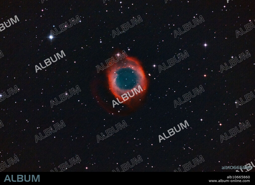 NGC-7293, The Helix Planetary Nebula in Aquarius; a wide field shot. The Helix Nebula, aka The Eye of God also known as The Helix, or NGC 7293, is a large planetary nebula (PN) located in the constellation Aquarius. Discovered by Karl Ludwig Harding, likely before 1824, this object is one of the closest to the Earth of all the bright planetary nebulae. This is a dying star blowing off it's outer atmosphere. Based on recent measured expansion rates this Planetary Nebula is about 10,600 years old. The central star is destined to become a white dwarf. The estimated distance is about 215 parsecs (700 light-years). It is similar in appearance to the Cat's Eye Nebula and the Ring Nebula, whose size, age, and physical characteristics are similar to the Dumbbell Nebula, varying only in its relative proximity and the appearance from the equatorial viewing angle. Modified Canon Rebel Xsi & 5.5 inch Newtonian Reflector, iSO 1600, for 180 minutes (3 hours) its not too bad for a 5 scope and.