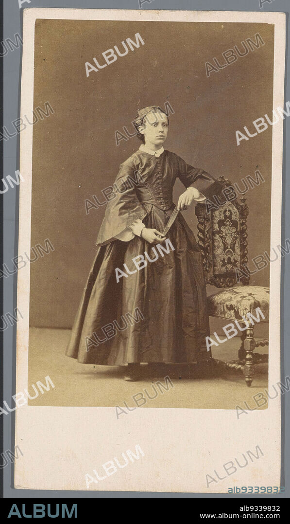 Portrait of an unknown young woman near a chair, Félix-Jacques Moulin (mentioned on object), Paris, 1855 - 1879, paper, cardboard, albumen print, height 112 mm × width 61 mm.