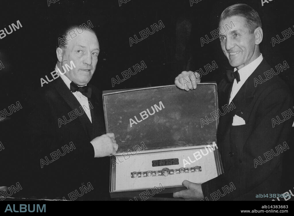 Photo Shows: Ted (Kid) Lewis (on left) receiving a miniature Lonsdale Belt from  his old rival and conqueror, Georges Carpentier, the famous French Veteran boxer, during the rournament.Old Rivals Meet Again In The Ring. A boxing tournament to help the Ted (Kid) Lewis, Fund was held at the empress Hall, Earl's Court, London. Lewis, formerly welterweight champion of the world was reckoned to be one of the greatest fighters of his age. September 19, 1950. (Photo by Sport & General Press Agency Limited).