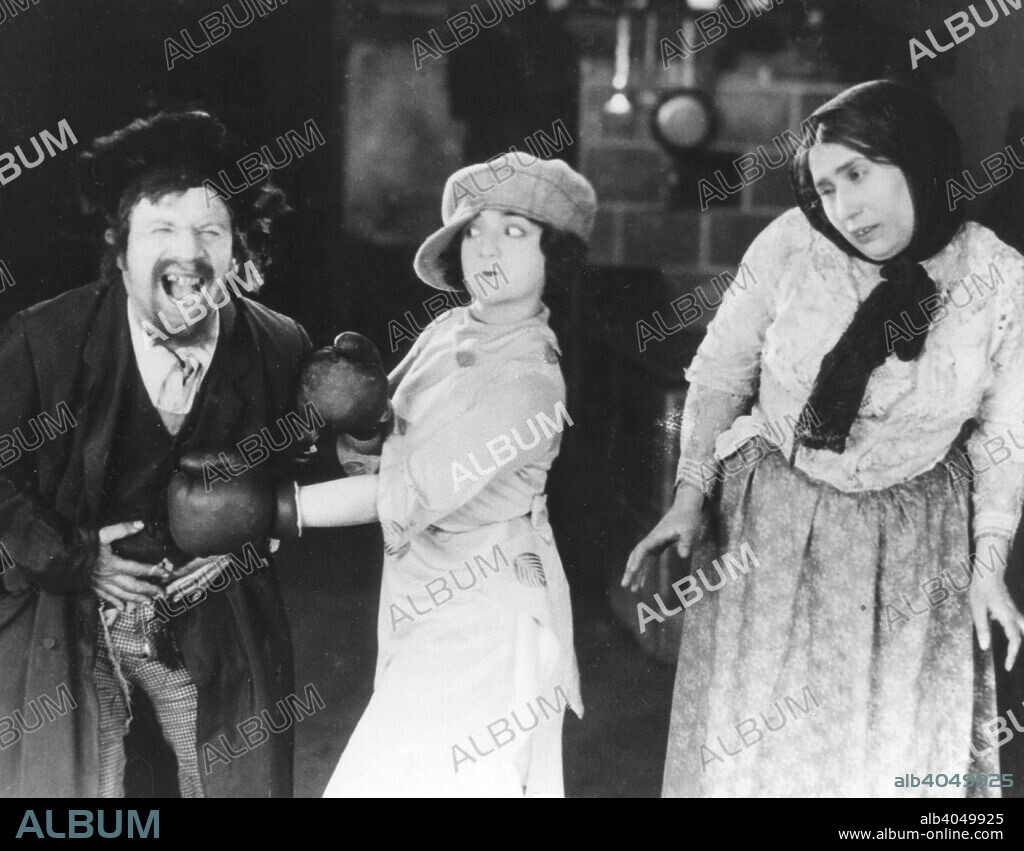 Scene from East and West, 1923. Silent film with English and Yiddish intertitles, starring Molly Picon (1898-1992) (centre), and Jacob Kalich (1891-1975). The film, directed by Sidney Goldin and Ivan Abramson, highlights the differences between New Yorker Picon, and her country cousins back in Eastern Europe.